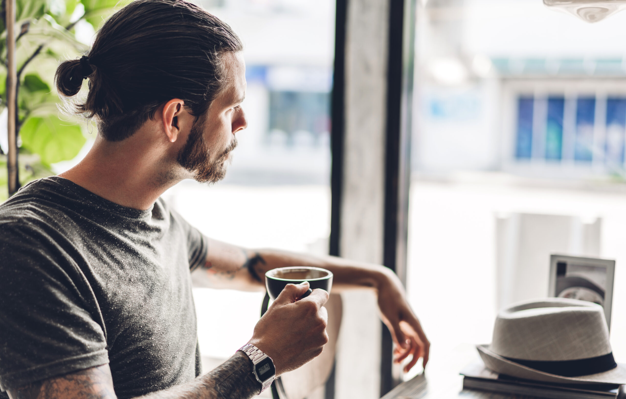 Handsome bearded hipster man relaxing holding and drink with cof
